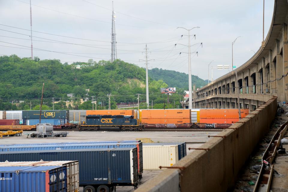 The Western Hills Viaduct, right, spans the CSX Queensgate Railroad Yard. The city will work closely with CSX to limit disruption to railyard activity as it builds a new bridge and takes down the current one in the next few years.