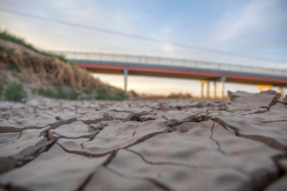 The cracked riverbed lays exposed in El Paso, Texas, on May 23, 2022. The riverbed below Elephant Butte Reservoir is often empty for most of the year, as the river only runs during irrigation season, which is shortened by drought.