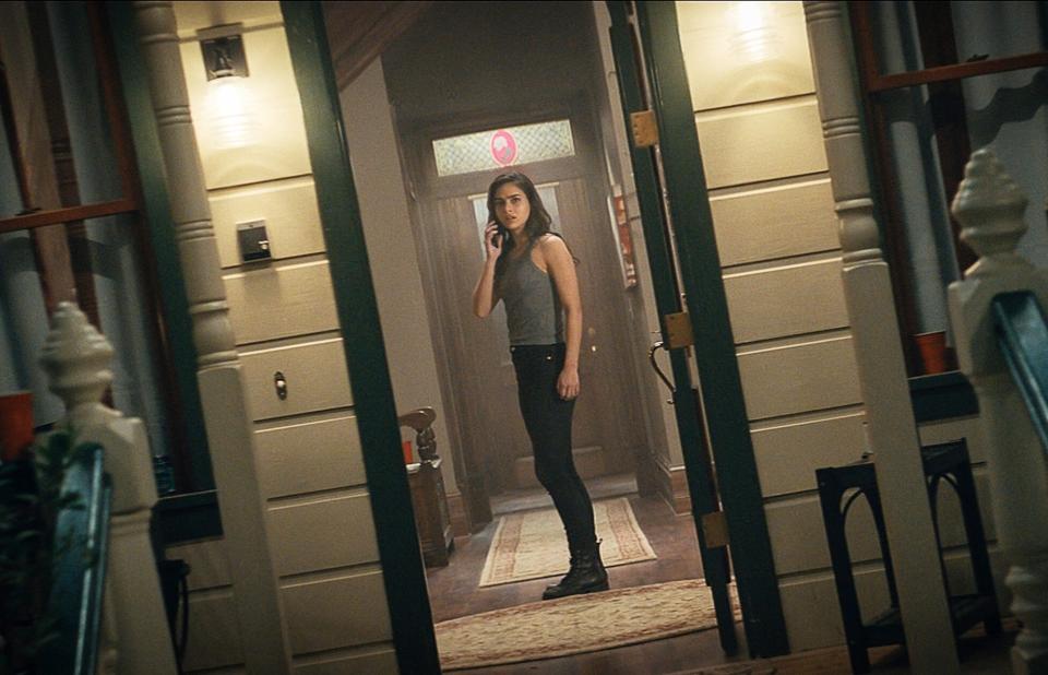 Melissa Barrera as Samantha Carpenter standing in Stu Macher's old house in "Scream 5"