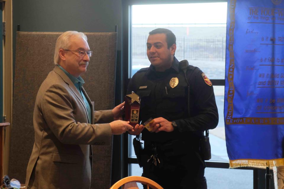 Patrol officer Enrique Gonzalez receives the 2022 Amarillo Police Officer of the Year award from David Low at the Amarillo South Rotary Club meeting Thursday in Amarillo.