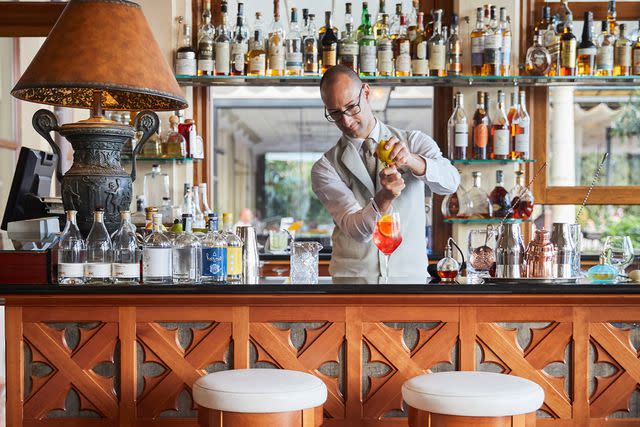 <p>Tyson Sadlo/Courtesy of Belmond</p> Mixing a cocktail at Bar Timeo, in Sicily.