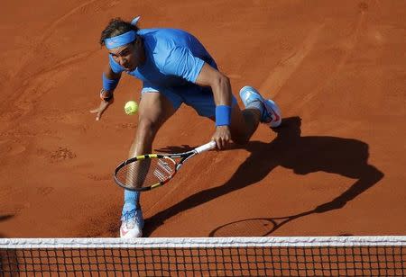 Rafael Nadal of Spain returns the ball to Novak Djokovic of Serbia during their men's quarter-final match during the French Open tennis tournament at the Roland Garros stadium in Paris, France, June 3, 2015. REUTERS/Vincent Kessler