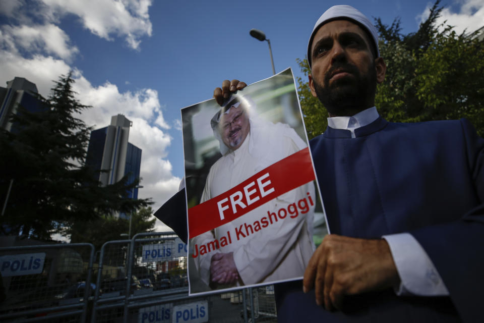 Holding a poster of missing Saudi writer Jamal Khashoggi, a man stands near the Saudi Arabia consulate in Istanbul, Friday, Oct. 5, 2018. Khashoggi, a 59-year-old veteran journalist who has lived in self-imposed exile in the U.S. since Prince Mohammed's rise to power, disappeared Oct. 2 while on a visit to the consulate to get paperwork done to be married to his Turkish fiancée. The Saudi Consulate insists Khashoggi left its building, contradicting Turkish officials who say they believe he is still there. (AP Photo/Emrah Gurel)
