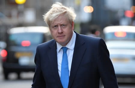 Boris Johnson, leader of the Britain's Conservative Party, leaves a private reception in central London