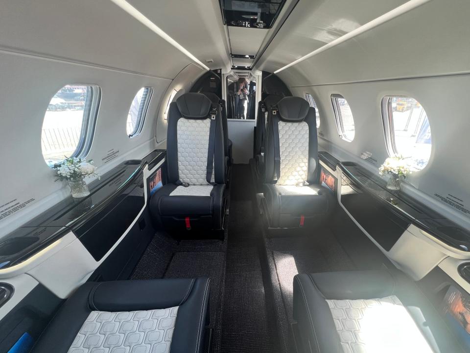 A view down the aisle of the cabin of an Embraer Phenom 300E