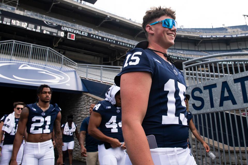 Penn State sophomore quarterback Drew Allar (15) smiles as he enters Beaver Stadium for football media day on Sunday, August 6, 2023, in State College.