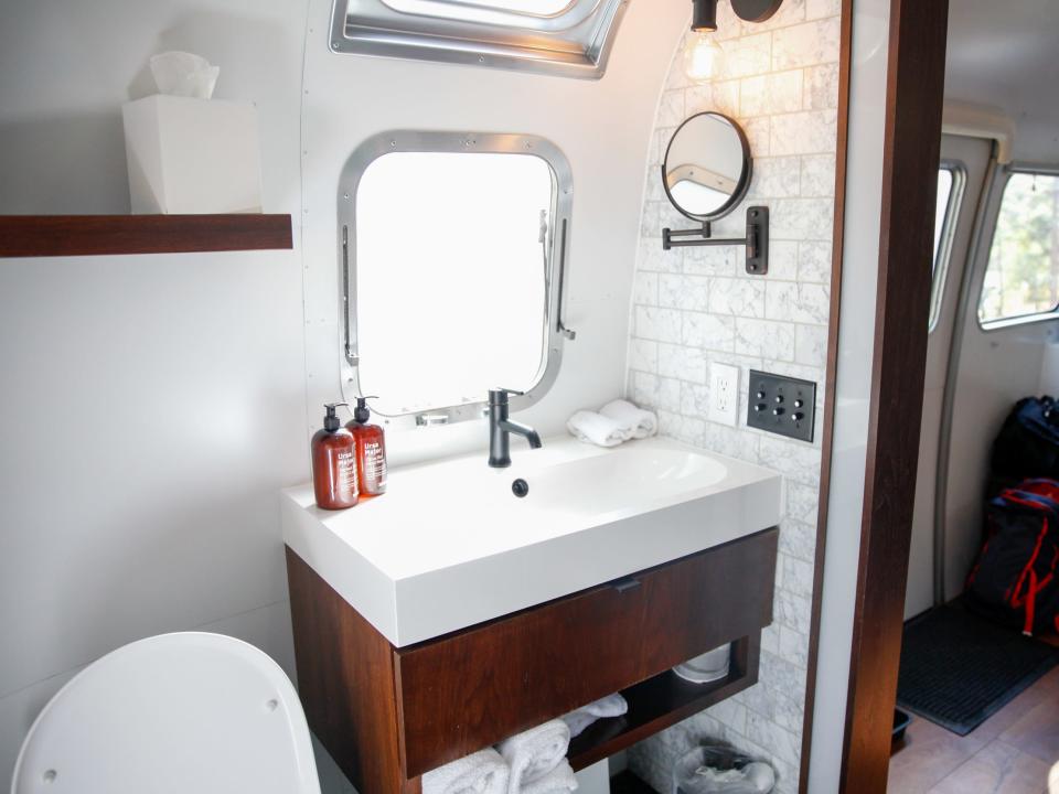 a sink with toiletries and windows