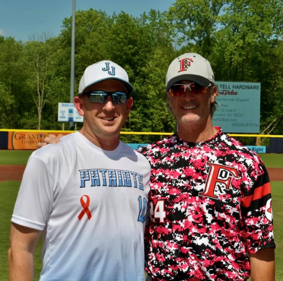 John Jay-East Fishkill baseball coach Eric Frink, left, poses alongside Fox Lane coach Matt Hillis before a 2023 game at Dutchess Stadium. The rival coaches have become close friends.