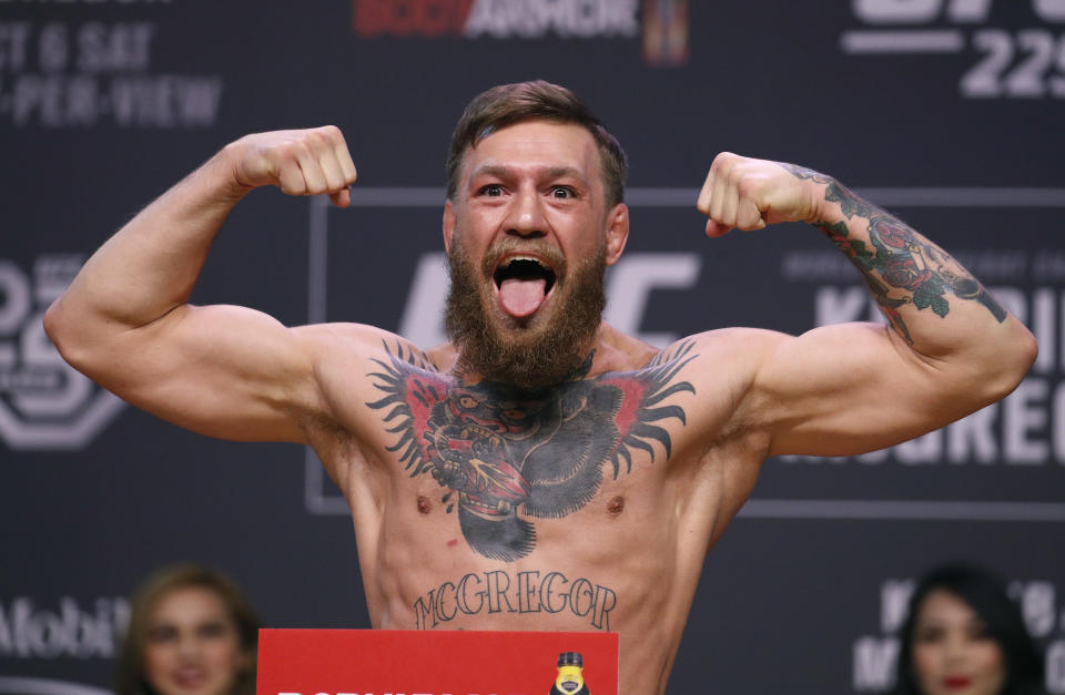 FILE - In this Oct. 5, 2018, file photo, Conor McGregor poses during a ceremonial weigh-in for the UFC 229 mixed martial arts fight in Las Vegas.  Superstar UFC fighter McGregor has announced on social media that he is retiring from mixed martial arts. McGregor’s verified Twitter account had a post early Tuesday, March 26, 2019,  that said the former featherweight and lightweight UFC champion was making a “quick announcement.”(AP Photo/John Locher, File)