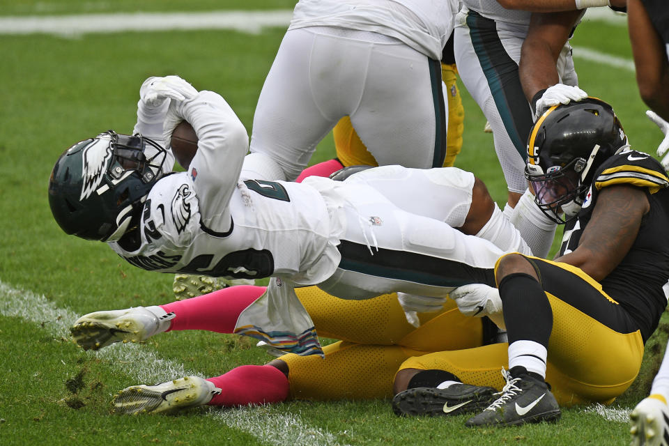 Philadelphia Eagles running back Miles Sanders (26), left, scores during the first half of an NFL football game against the Pittsburgh Steelers in Pittsburgh, Sunday, Oct. 11, 2020. (AP Photo/Don Wright)