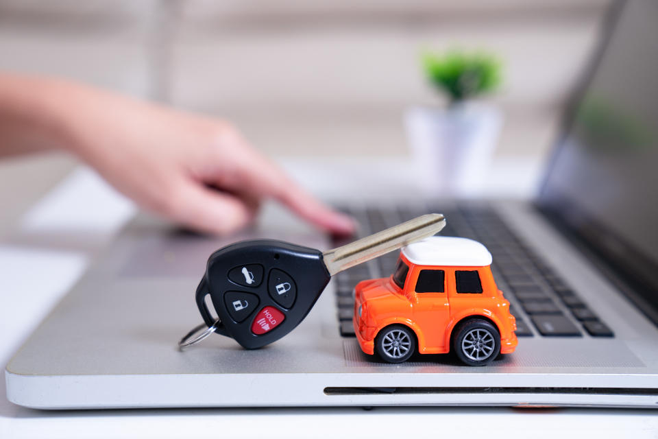 Close-up Of A Small Car On Laptop ,selling car online,selling car and shopping,