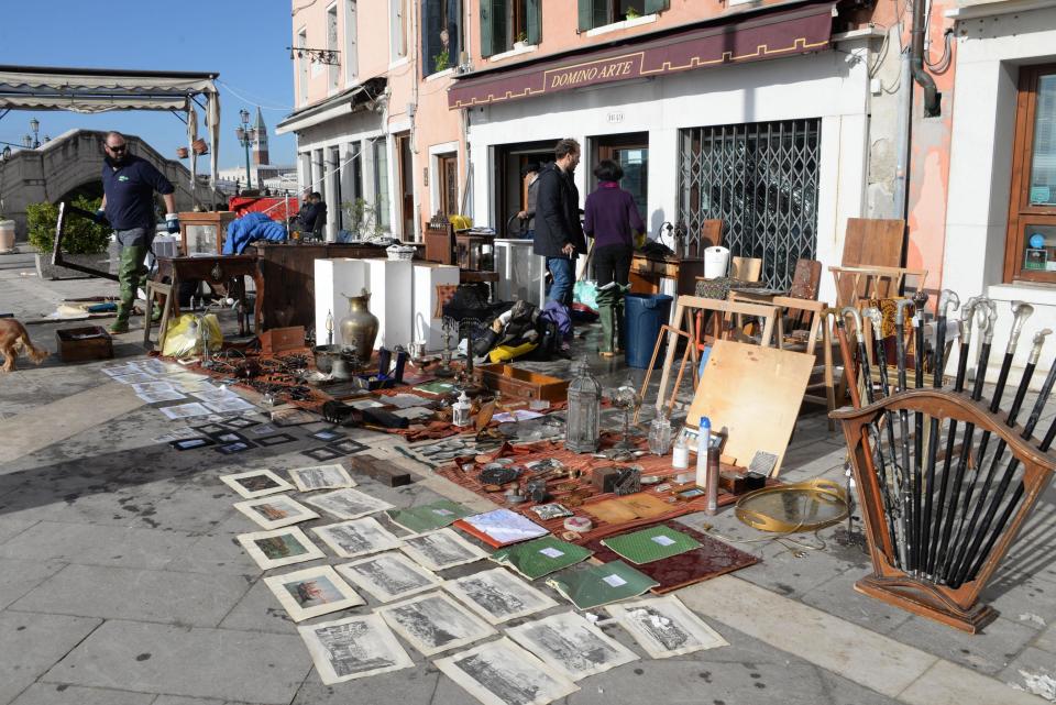 Sketches and drawings are lined up to dry up outside an art store following a flooding in Venice, Italy, Thursday, Nov. 14, 2019. The worst flooding in Venice in more than 50 years has prompted calls to better protect the historic city from rising sea levels as officials calculated hundreds of millions of euros in damage. The water reached 1.87 meters above sea level Tuesday, the second-highest level ever recorded in the city. (Andrea Merola/ANSA via AP)
