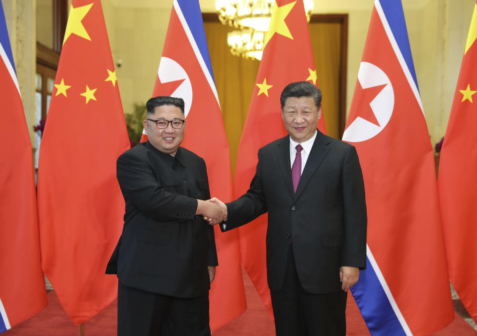 FILE- In this June 19, 2018, file photo provided by China's Xinhua News Agency, Chinese President Xi Jinping, right, shakes hands with North Korean leader Kim Jong Un, during a welcome ceremony at the Great Hall of the People in Beijing. Kim arrived in Beijing on Tuesday, Jan. 8, 2019 for his fourth summit with China’s Xi Jinping. Kim’s first foray outside of North Korea as leader was for a summit with Xi last March. The two met again in May and June, just ahead of and just after Kim’s June 12 summit with Trump in Singapore. (Ju Peng/Xinhua via AP, File)