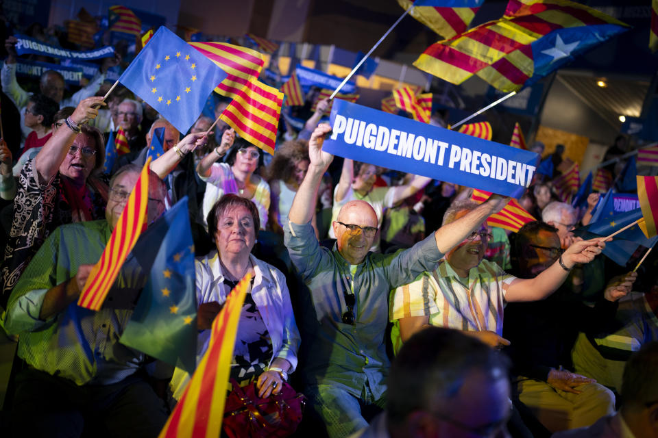 Supporters of Catalonia's former regional president Carles Puigdemont react during a campaign rally in Argelers, France, Wednesday, May 8, 2024. Carles Puidgemont, Catalonia's fugitive former leader, stares confidently out the backseat window of a car, the sun illuminating his gaze in a campaign poster for Sunday's critical elections in the northeastern Spanish region. Some nearly 6 million Catalans are called to cast ballots in regional elections on Sunday that will surely have reverberations in Spain's national politics. (AP Photo/Joan Mateu)