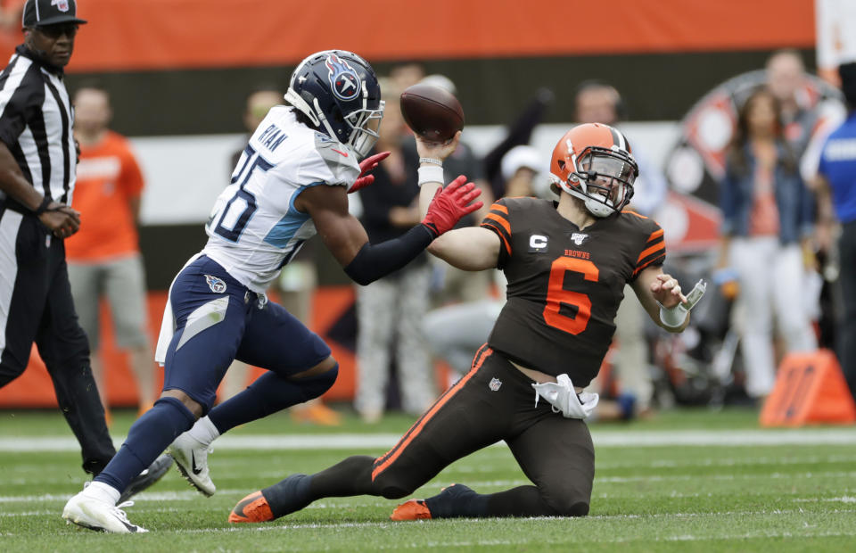 Cleveland Browns quarterback Baker Mayfield (6) throws under pressure from Tennessee Titans cornerback Logan Ryan (26) during the first half in an NFL football game, Sunday, Sept. 8, 2019, in Cleveland. (AP Photo/Ron Schwane)