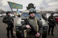 Ukrainian National guard soldiers guard the mobile checkpoint toghether with the Ukrainian Security Service agents and police officers during a joint operation in Kharkiv, Ukraine, Thursday, Feb. 17, 2022. Fears of a new war in Europe have resurged as U.S. President Joe Biden warned that Russia could invade Ukraine within days, and violence spiked in a long-running standoff in eastern Ukraine that some fear could be the spark for wider conflict. (AP Photo/Evgeniy Maloletka)