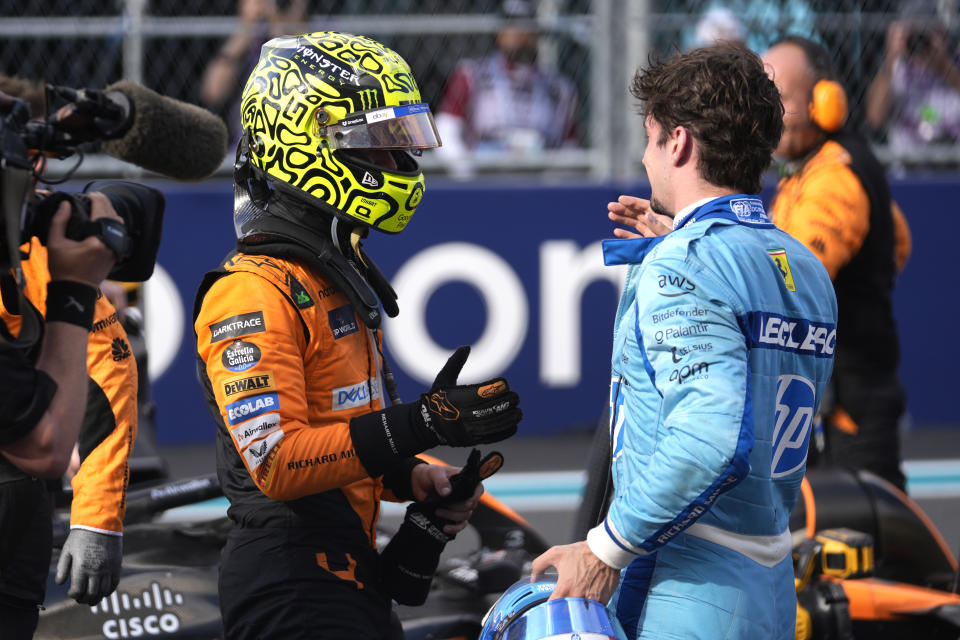 McLaren driver Lando Norris, left, of Britain, shakes hands with Ferrari driver Charles Leclerc, of Monaco, after winning the Miami Formula One Grand Prix auto race Sunday, May 5, 2024, in Miami Gardens, Fla. (AP Photo/Rebecca Blackwell)