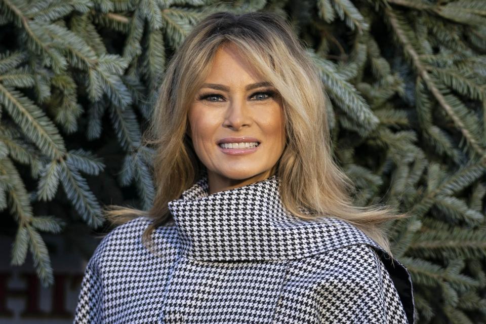 U.S. First Lady Melania Trump stands in front of the White House Christmas Tree at the North Portico of the White House in Washington, D.C., U.S., on Monday, Nov. 23, 2020. Oregon residents Dan and Anne Taylor of West's Tree Farm presented the Christmas Tree and the tree will be displayed in the White House Blue Room. Photographer: Sarah Silbiger/Bloomberg via Getty Images