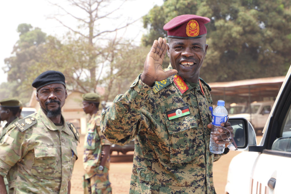 In this photo dated Thursday, Jan. 1 2019, James Nando, opposition commander accused of having child soldiers in his care, waves as he walks to his car after Government and opposition forces came together for one of many meetings aimed at building confidence for a peace deal between the opposing forces, in the town of Yambio, South Sudan. Officials sad Thursday Feb. 21 2019, that evidence from numerous accounts, suggest that South Sudan's rival armed groups are forcefully recruiting civilians, including child soldiers, violating a fragile peace deal signed five months ago. (AP Photo/Sam Mednick)