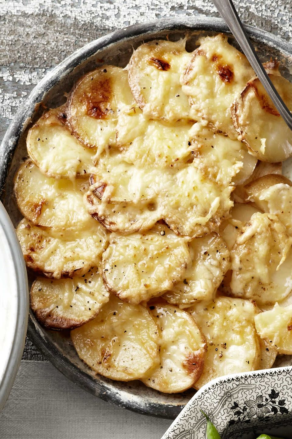 <p>Celery root lends unique flavor and freshness, as well as a touch more nutrition to this variation on a classic potato gratin.</p><p><strong>Quick tip</strong>: A mandoline slices potatoes uniformly and paper-thin. <br></p><p><strong><a href="https://www.countryliving.com/food-drinks/recipes/a3574/potato-celery-root-gratin-recipe-clv0211/" rel="nofollow noopener" target="_blank" data-ylk="slk:Get the recipe;elm:context_link;itc:0;sec:content-canvas" class="link ">Get the recipe</a>.</strong></p><p><a class="link " href="https://www.amazon.com/Prepworks-by-Progressive-Adjust-A-Slice-Mandoline/dp/B001QGPHXM/?tag=syn-yahoo-20&ascsubtag=%5Bartid%7C10050.g.33370793%5Bsrc%7Cyahoo-us" rel="nofollow noopener" target="_blank" data-ylk="slk:SHOP MANDOLINES;elm:context_link;itc:0;sec:content-canvas">SHOP MANDOLINES</a></p>