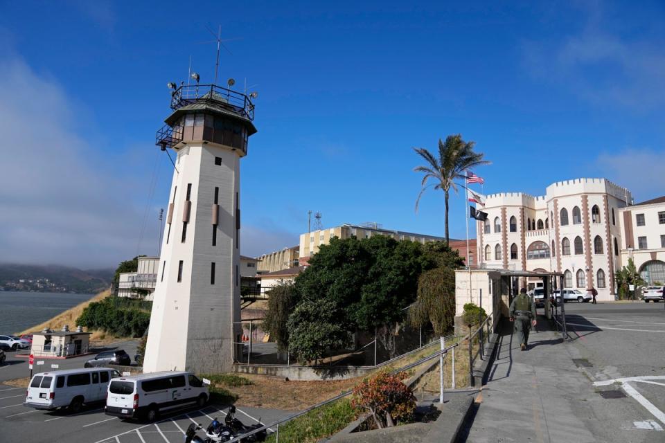 A correctional officer walks up a main entryway at San Quentin State Prison in San Quentin, California (Associated Press)