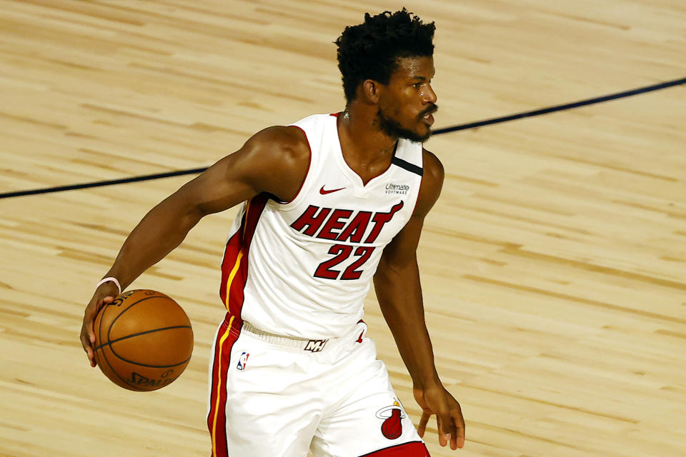 Miami Heat's Jimmy Butler dribbles up court during the first half of an NBA basketball game against the Denver Nuggets, Saturday, Aug. 1, 2020, in Lake Buena Vista, Fla. (Kevin C. Cox/Pool Photo via AP)