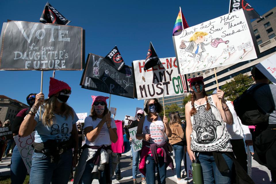 People rally during the Women's March at Freedom Plaza, Saturday, Oct. 17, 2020, in Washington.