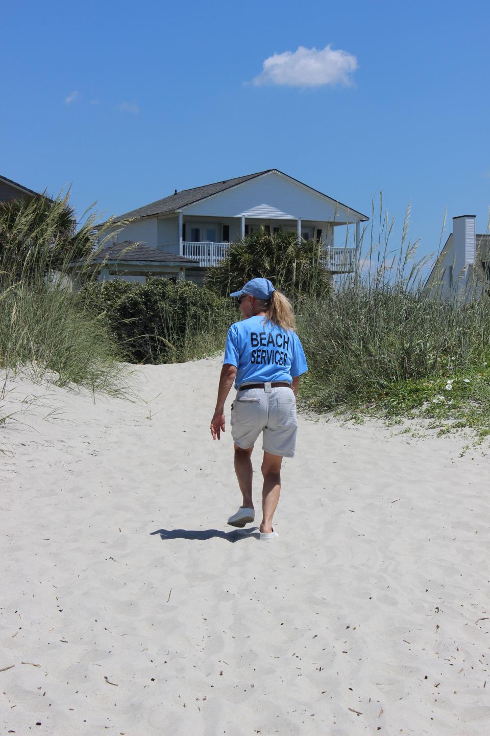 Cynthia Grant, an employee with Oak Island's Beach Services Unit, checks on a parking complaint at one of the town's public beach accesses.