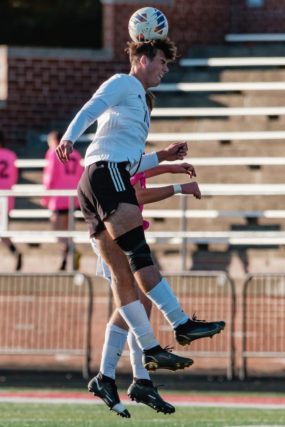 New Phila's Javen Doss goes up for a header against Dover's Eric Smith, Saturday, Oct. 15 at Crater Stadium.