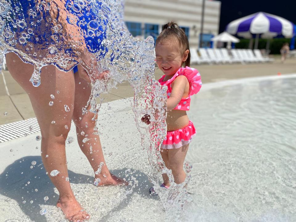 Zia Ramirez, 3, plays with a water attraction as her mother, Marlen Leon, watches while in the pool at Flash Flood Water Park in downtown Battle Creek Monday, June 13, 2022.