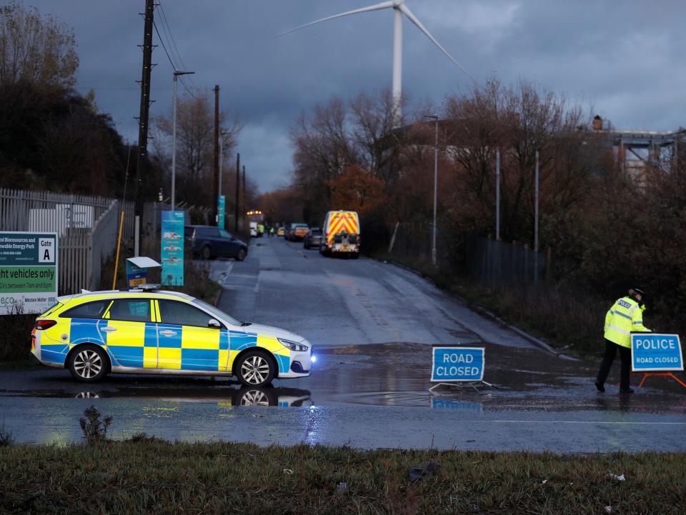 <p>Police closed a nearby road while a helicopter looked for missing people</p>Peter Nicholls/Reuters