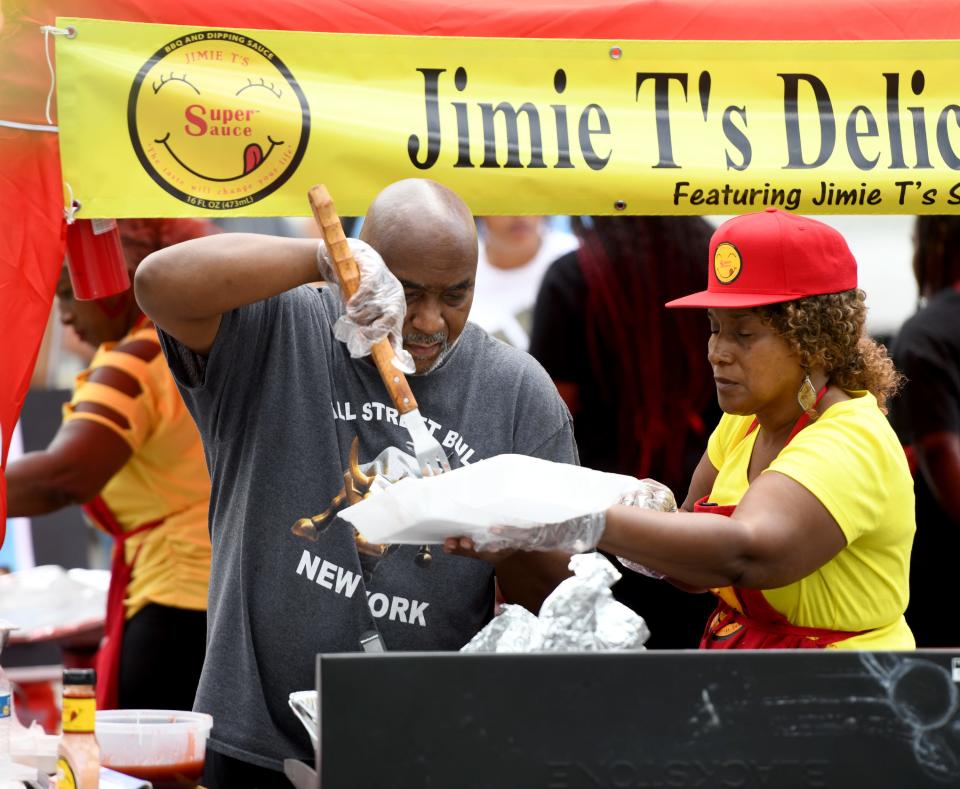 Jimie and Rose Fowler of Canton serve ribs Friday at EN-RICH-MENT'S third annual African American Arts Festival at Centennial Plaza in Canton.