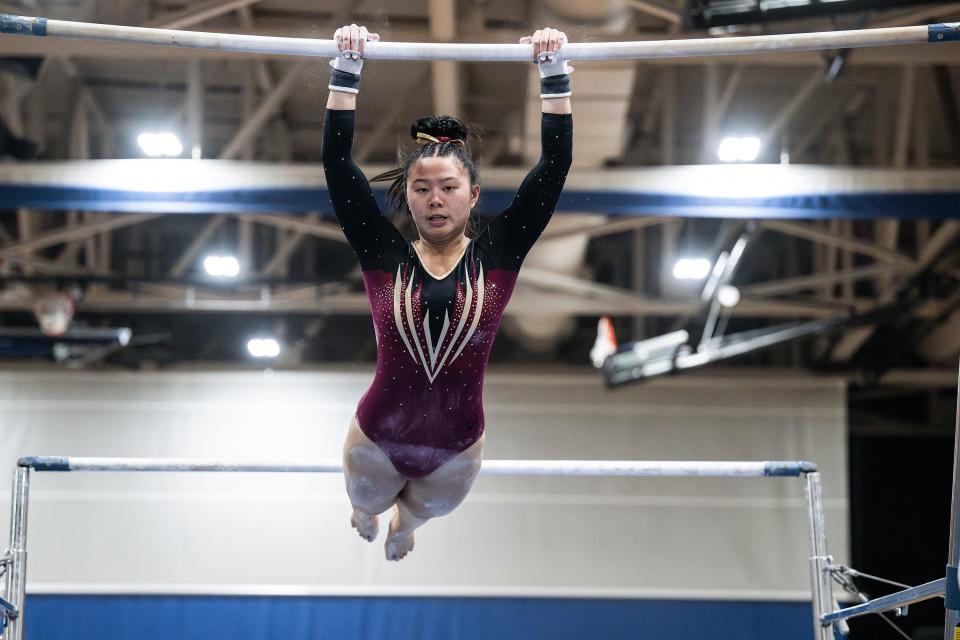 Algonquin senior captain Maddie Ho competes on the bars during the Mid-Wach gymnastics championship Saturday at Shrewsbury High.