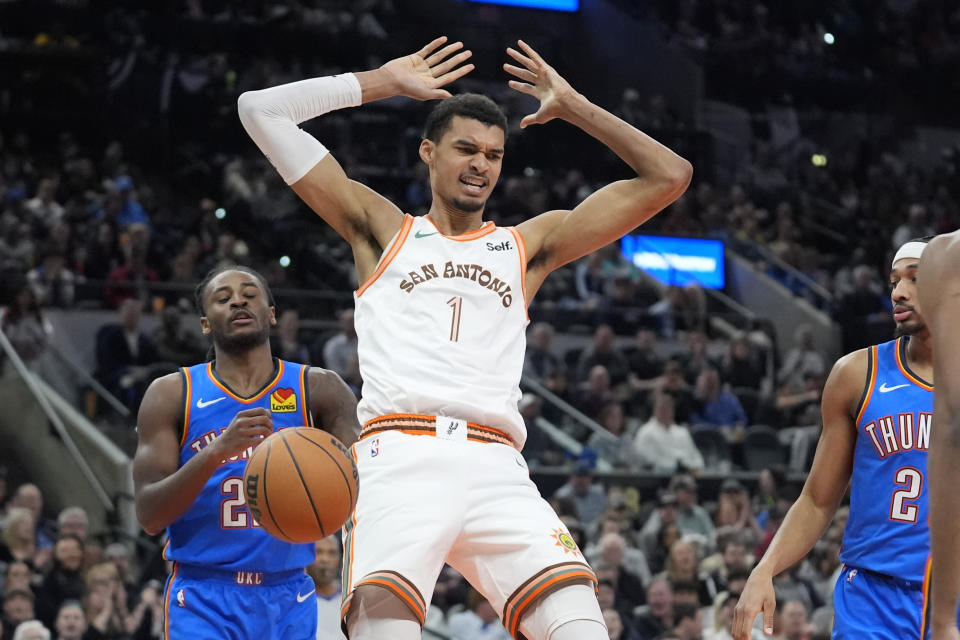 San Antonio Spurs center Victor Wembanyama (1) reacts after scoring against the Oklahoma City Thunder during the first half of an NBA basketball game in San Antonio, Wednesday, Jan. 24, 2024. (AP Photo/Eric Gay)