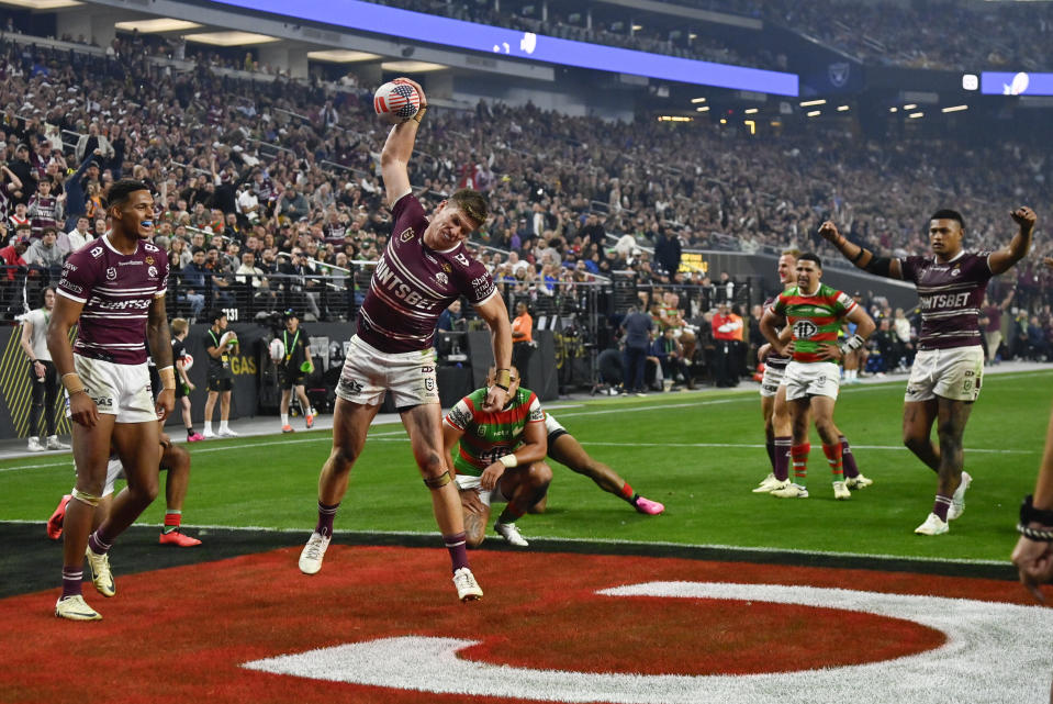 Sea Eagles Reuben Garrick, centre, celebrates after scoring a try during the opening match of the NRL between the Manly Warringah Sea Eagles and the South Sydney Rabbitohs at Allegiant Stadium in Las Vegas, Saturday, March 2, 2024. (AP Photo/David Becker)
