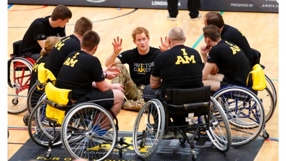 Prince Harry talks with wheelchair basketball players during the launch of the Invictus Games at the Copper Box Arena in the Queen Elizabeth Olympic Park on March 6, 2014 in London, England