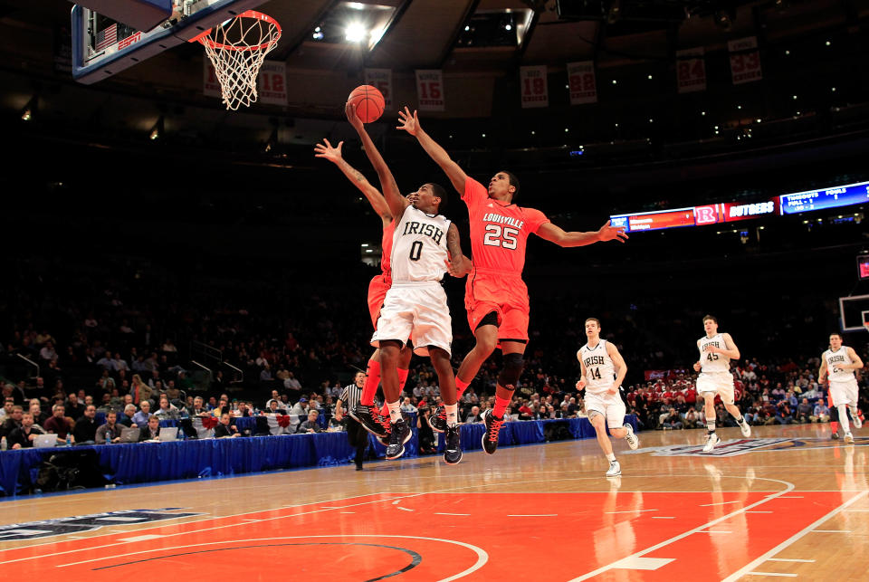 NEW YORK, NY - MARCH 09: Peyton Siva #3 and Wayne Blackshear #25 of the Louisville Cardinals jump to block the shot of Eric Atkins #0 of the Notre Dame Fighting Irish during the semifinals of the Big East men's basketball tournament at Madison Square Garden on March 9, 2012 in New York City. (Photo by Chris Trotman/Getty Images)