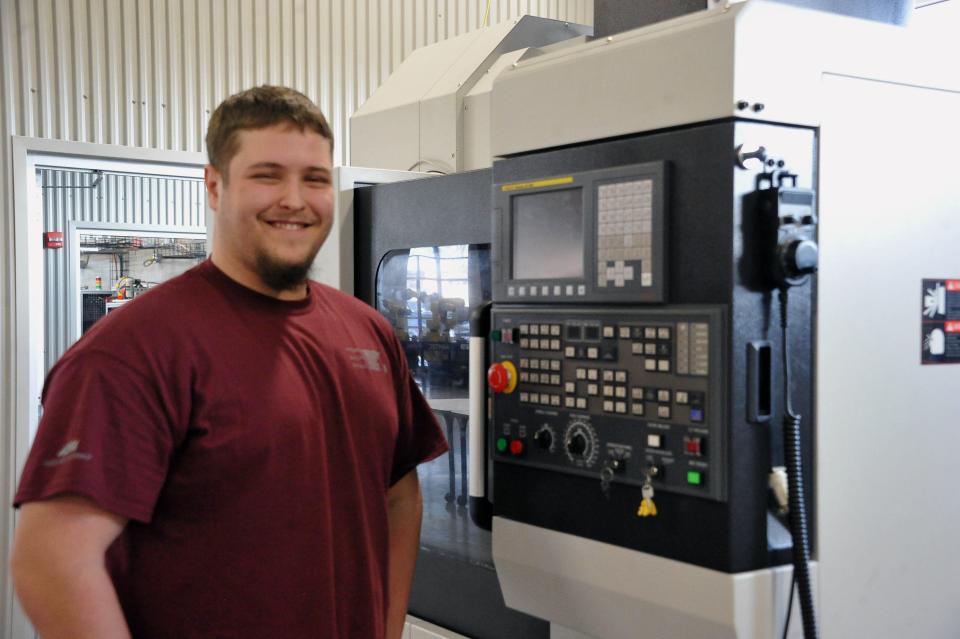 Gavin Maibach stands at the controls of a CNC metal machine he works with at the Wayne County Schools Career Center. As he looks to future employment, he said he just wants to make sure he can take care of his future family and thinks a salary in the low six figures or high five figures should accomplish that.