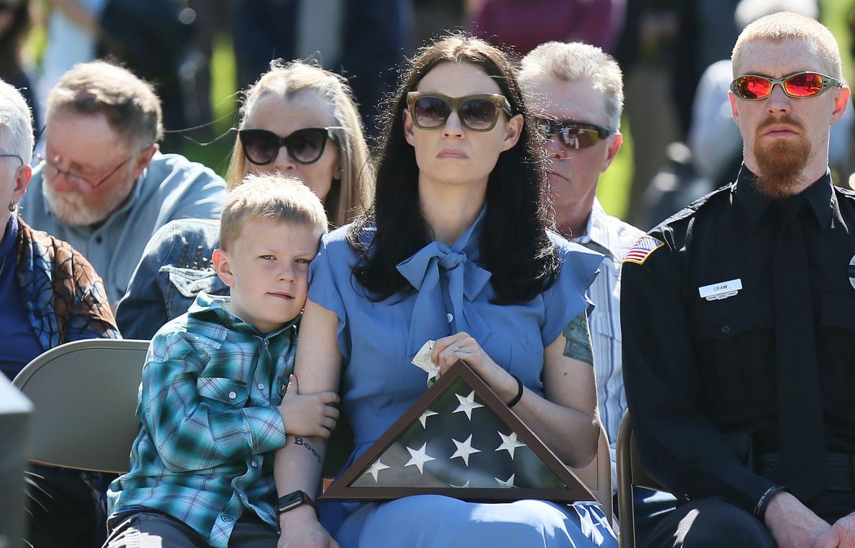 Kevin Cram’s widow, Lara Cram, and his son, Weston, pay tribute during a memorial ceremony for the two fallen Iowa police officers at the Iowa Peace Officer Memorial on Friday, May 10, 2024, in Des Moines, Iowa.