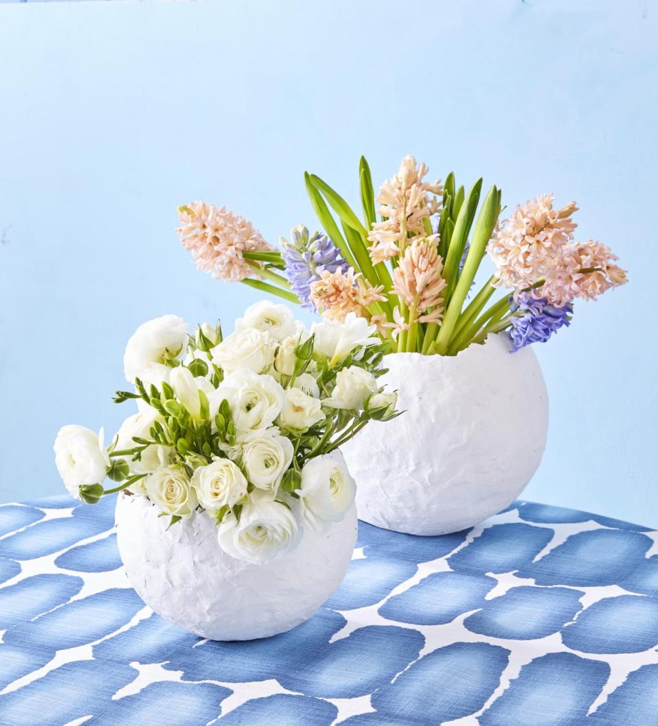 paper mache egg vase filled with flowers