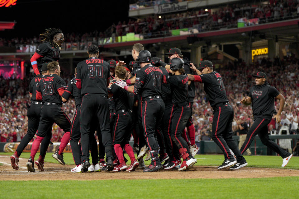 Cincinnati Reds' Christian Encarnacion-Strand celebrates with teammates after hitting a walkoff home run against the Toronto Blue Jays in the ninth inning of a baseball game in Cincinnati, Friday, Aug. 18, 2023. (AP Photo/Jeff Dean)