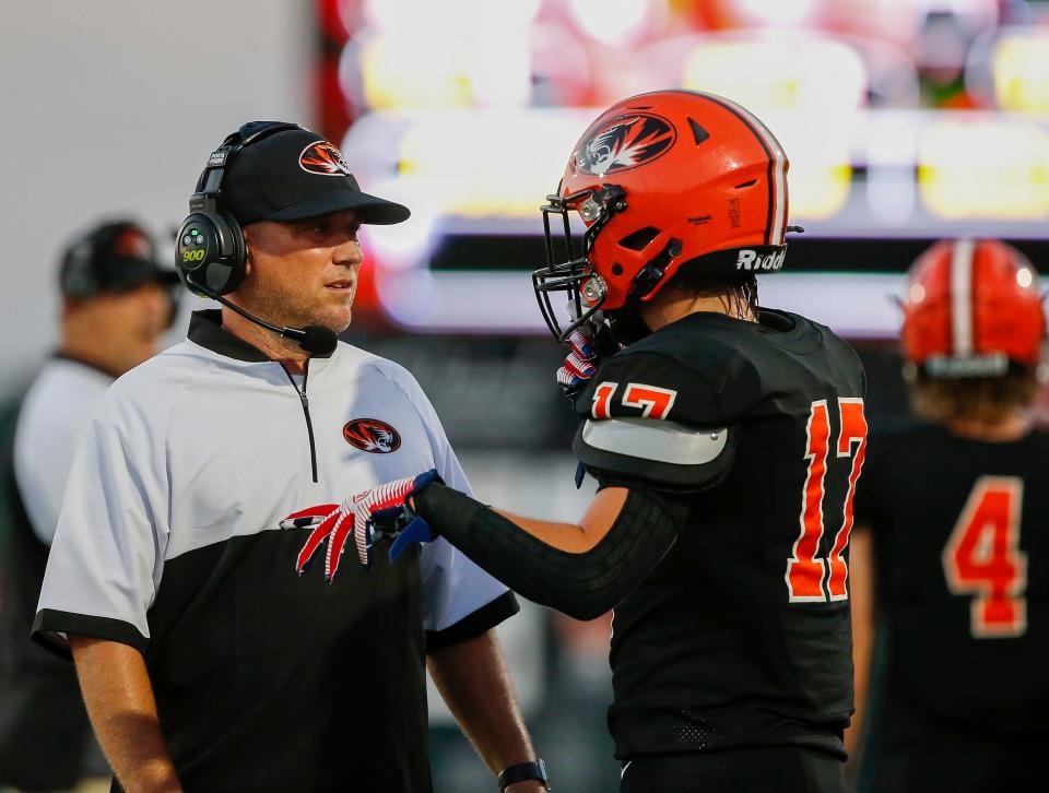Republic head coach Ryan Cornelsen talks to Cole Gimlin during the Tigers 47-12 win over Neosho in the season opener at Republic High School on Friday, Aug. 27, 2021.