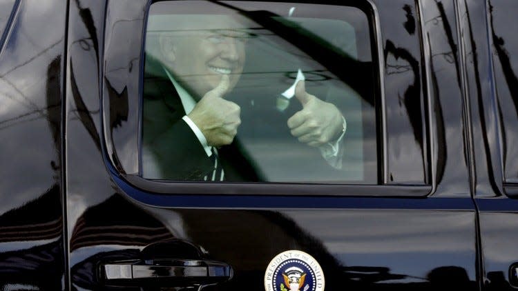 President Donald Trump smiles and gives two thumbs up to supporters on Southern Boulevard as his motorcade heads to Mar-a-Lago Friday, March 2, 2018.