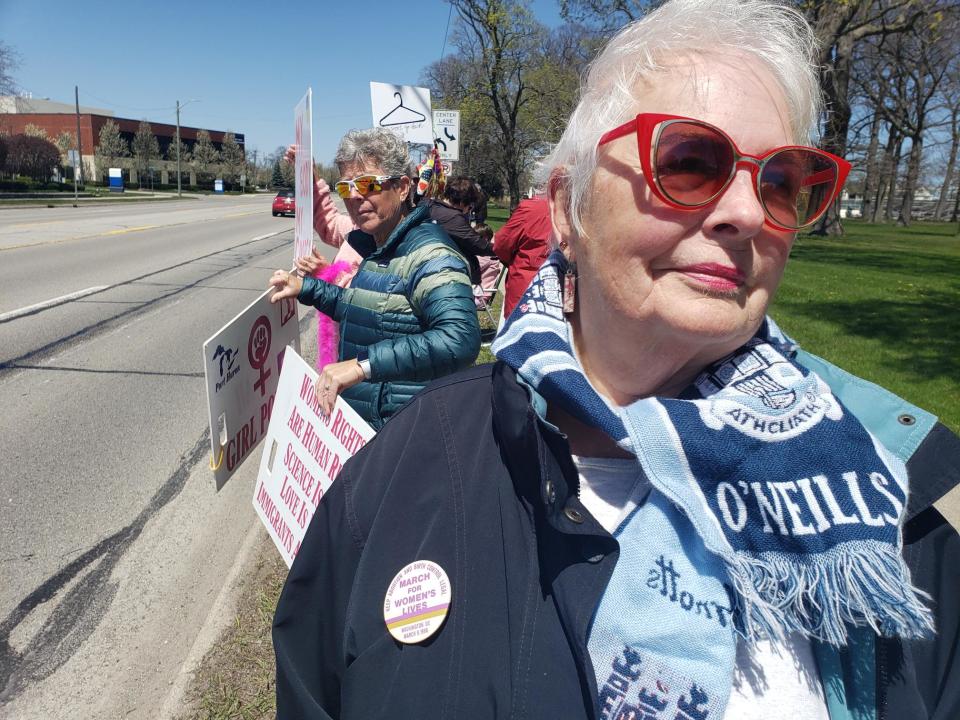 Lesley Lambright, 75, of Lakeport, shows off a pin from a women's march in Washington, D.C. in 1986. Lambright was attending an abortion rights demonstration in Pine Grove Park Saturday, May 7, 2022.