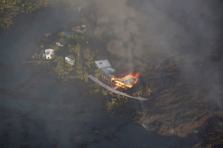 Lava destroys homes in the Kapoho area, east of Pahoa, during ongoing eruptions of the Kilauea Volcano in Hawaii, U.S., June 5, 2018. REUTERS/Terray Sylvester