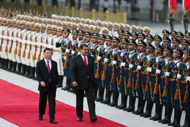 Venezuela President Nicolas Maduro (right) and his Chinese counterpart Xi Jinping walking during a welcoming ceremony in Beijing