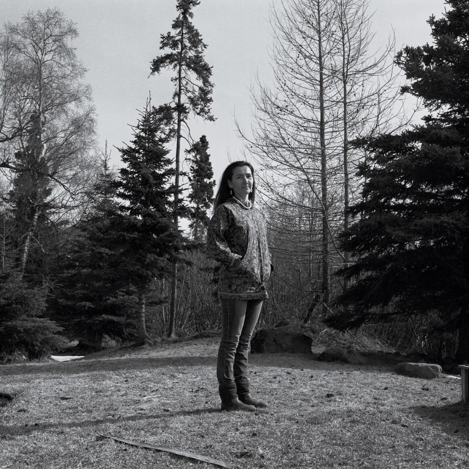 mary peltola standing outside surrounded by trees