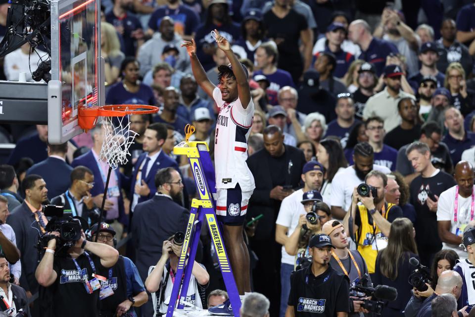 Apr 3, 2023; Houston, TX, USA; Connecticut Huskies guard Tristen Newton (2) celebrates while cutting the nut after defeating the San Diego State Aztecs in the national championship game of the 2023 NCAA Tournament at NRG Stadium. Mandatory Credit: Troy Taormina-USA TODAY Sports