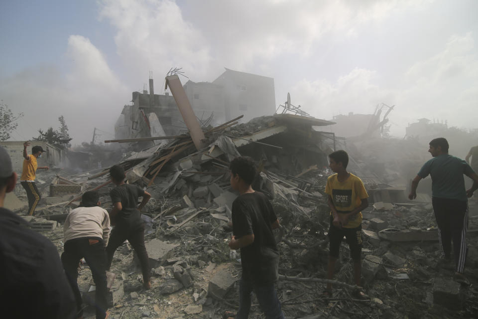 Palestinians look for survivers in buildings destroyed in the Israeli bombardment of the Gaza Strip in Rafah, Sunday, Oct. 22, 2023. (AP Photo/Hatem Ali)