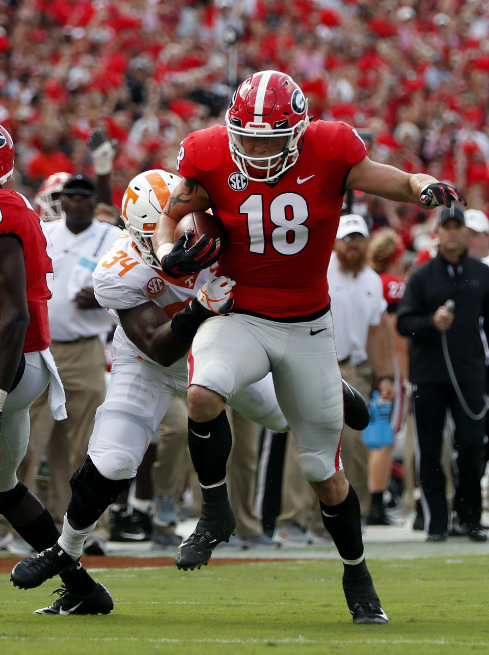 Georgia tight end Isaac Nauta (18) gets away from Tennessee linebacker Darrin Kirkland Jr. (34) as he scores after recovering quarterback Jake Fromm's fumble in the first half of an NCAA college football game Saturday, Sept. 29, 2018, in Athens, Ga. (AP Photo/John Bazemore)